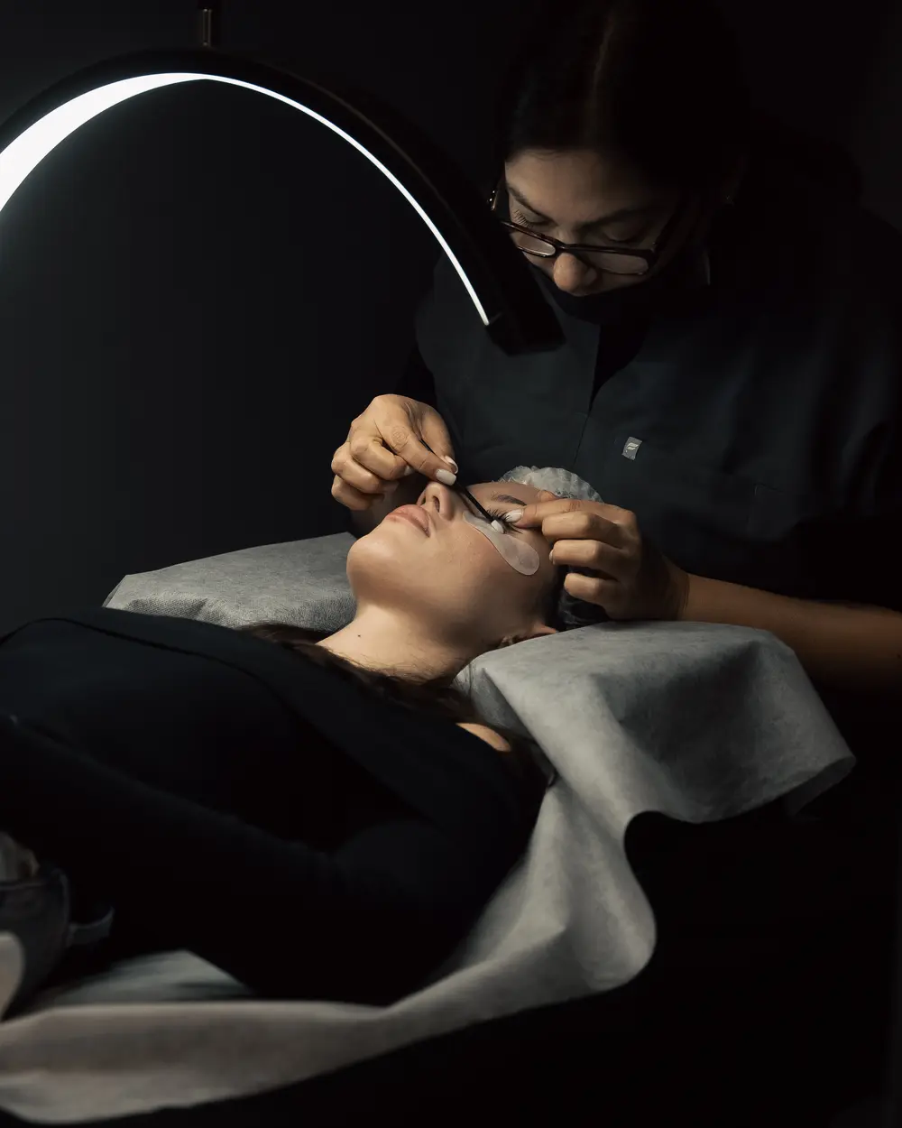 Volume lash extensions being applied under a ring light