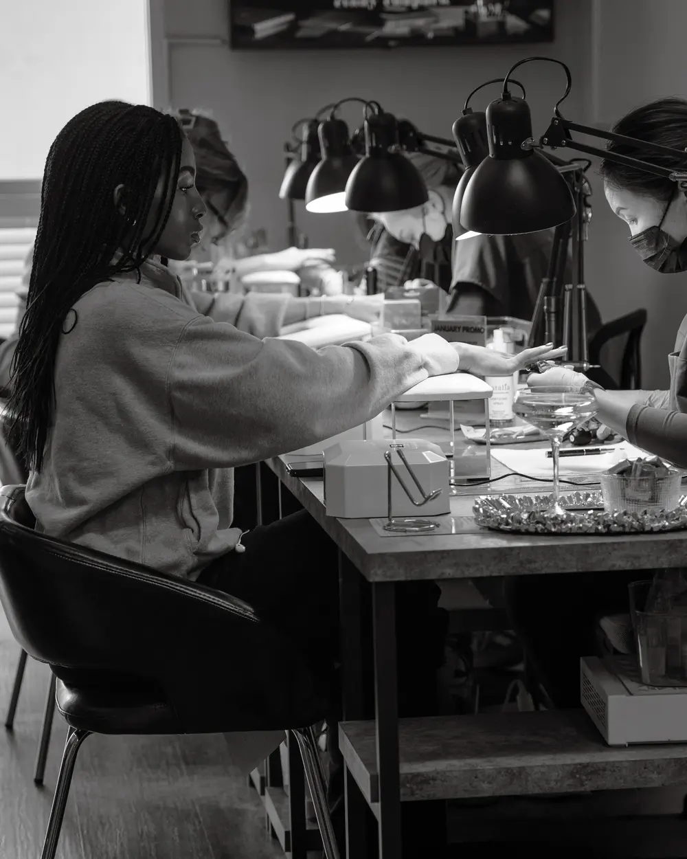The manicure bar on a busy day, black and white