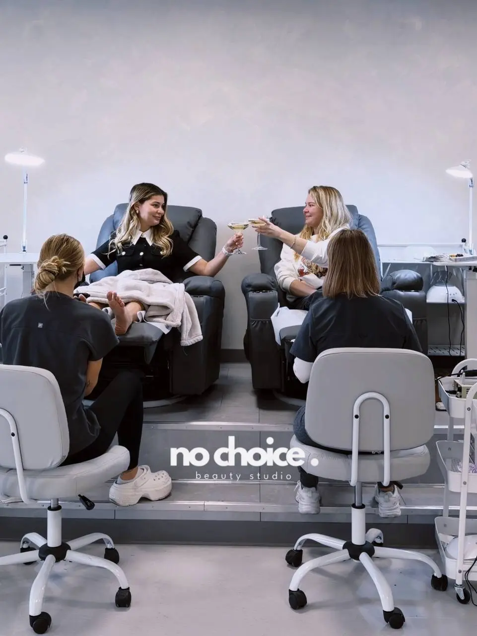 Pedicure lounge at the Huntington Beach studio, clients toasting champagne