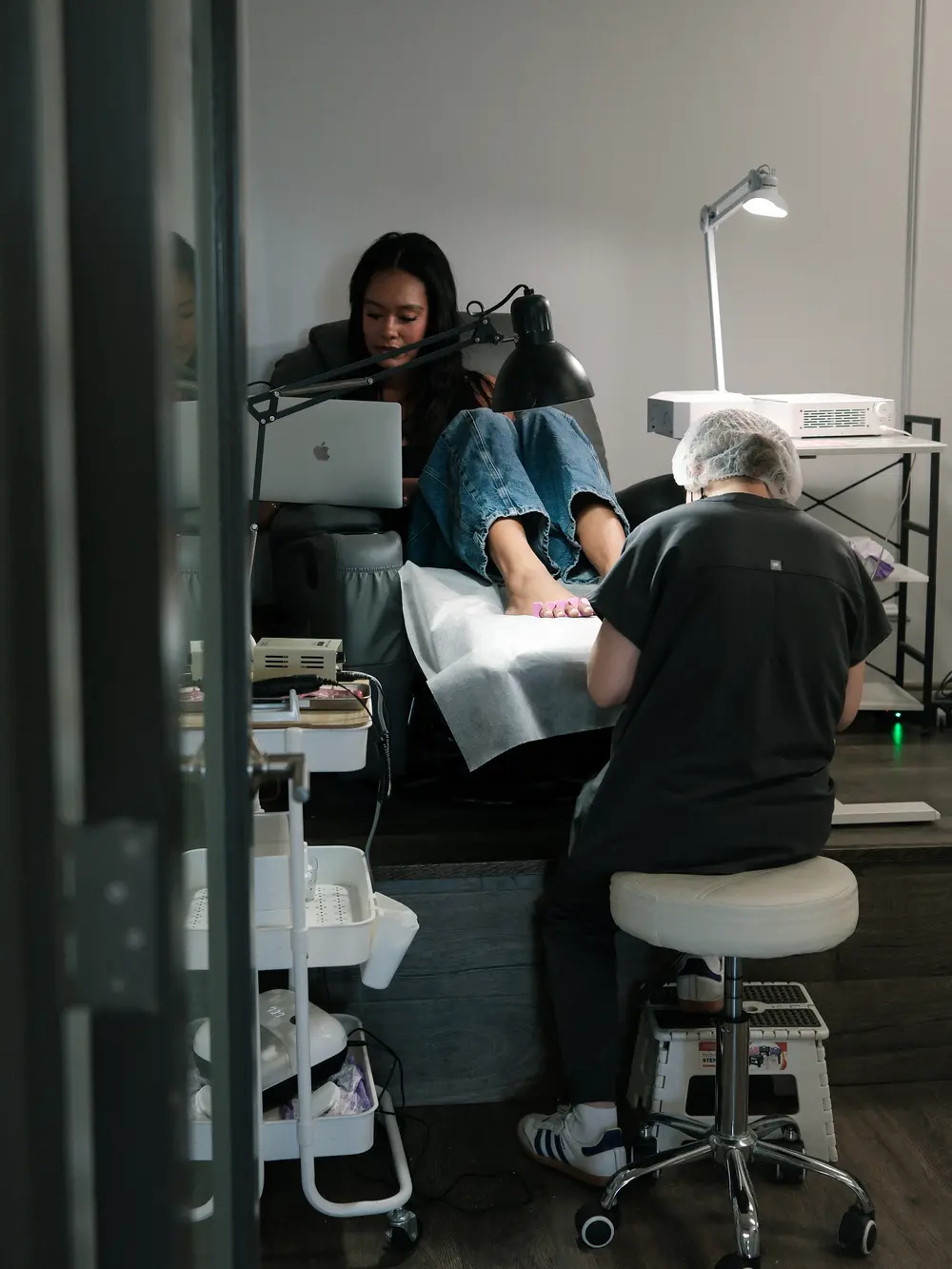 Pedicure in progress under the lamp at the Los Angeles studio